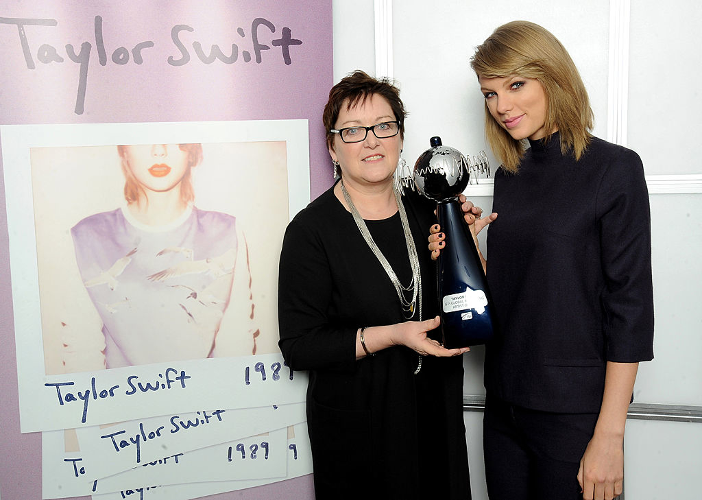 Taylor Swift and a woman holding an award