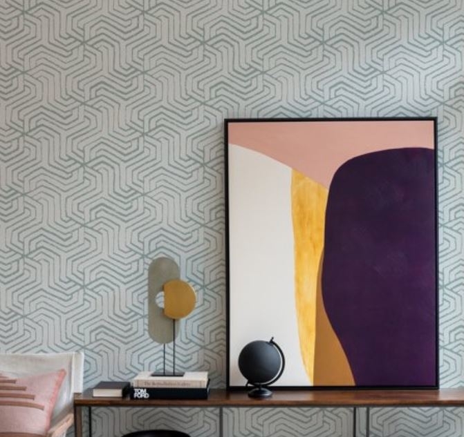 modern framed artwork next to geometric wallpaper
