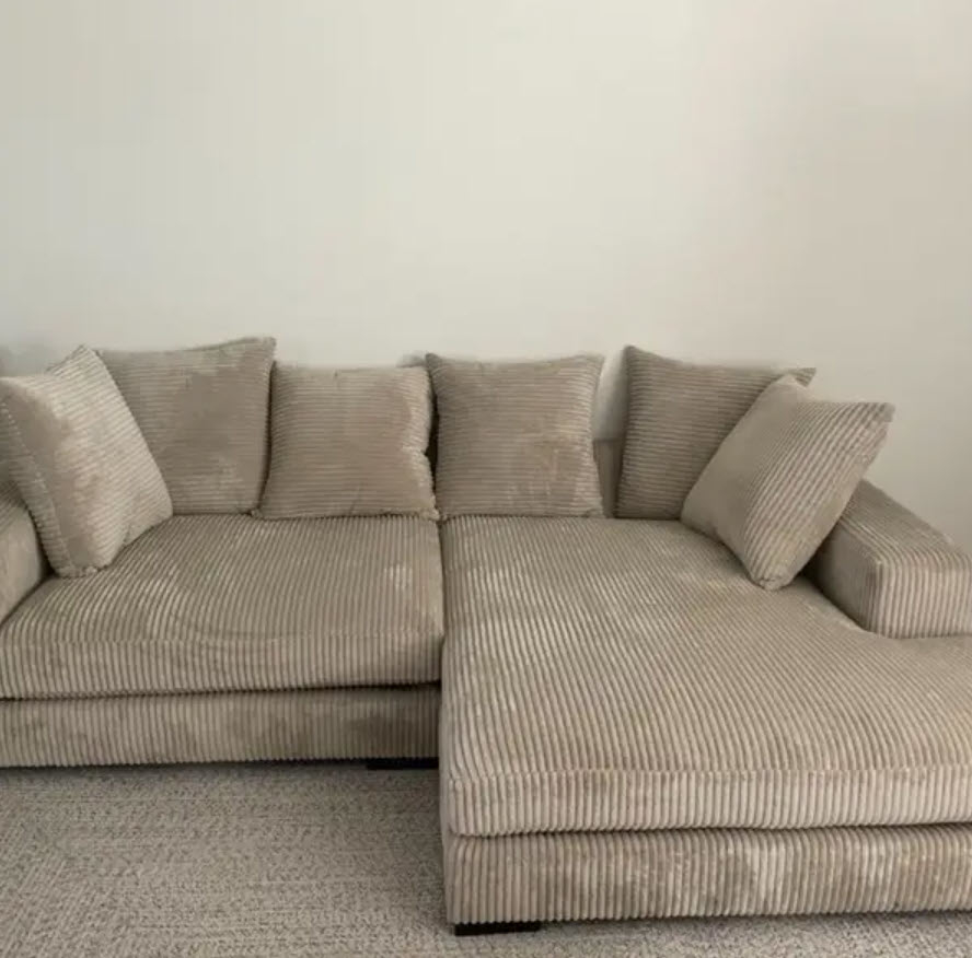 beige velvet ribbed sectional couch with pillows