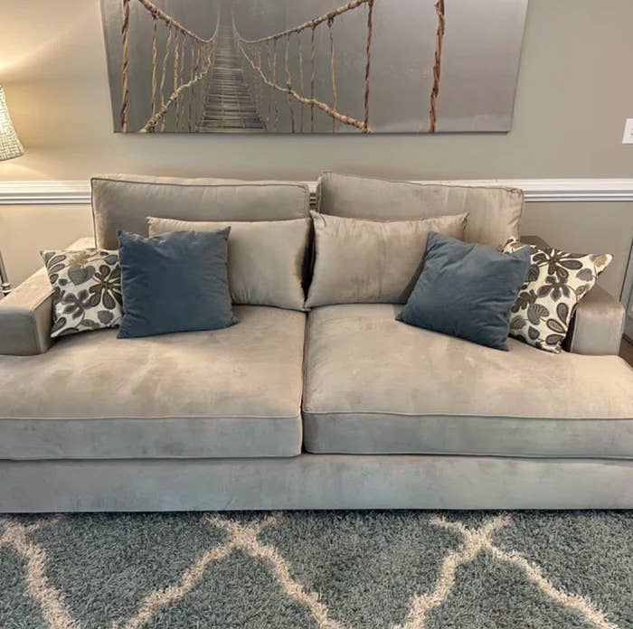beige/taupe velvet couch with throw pillows