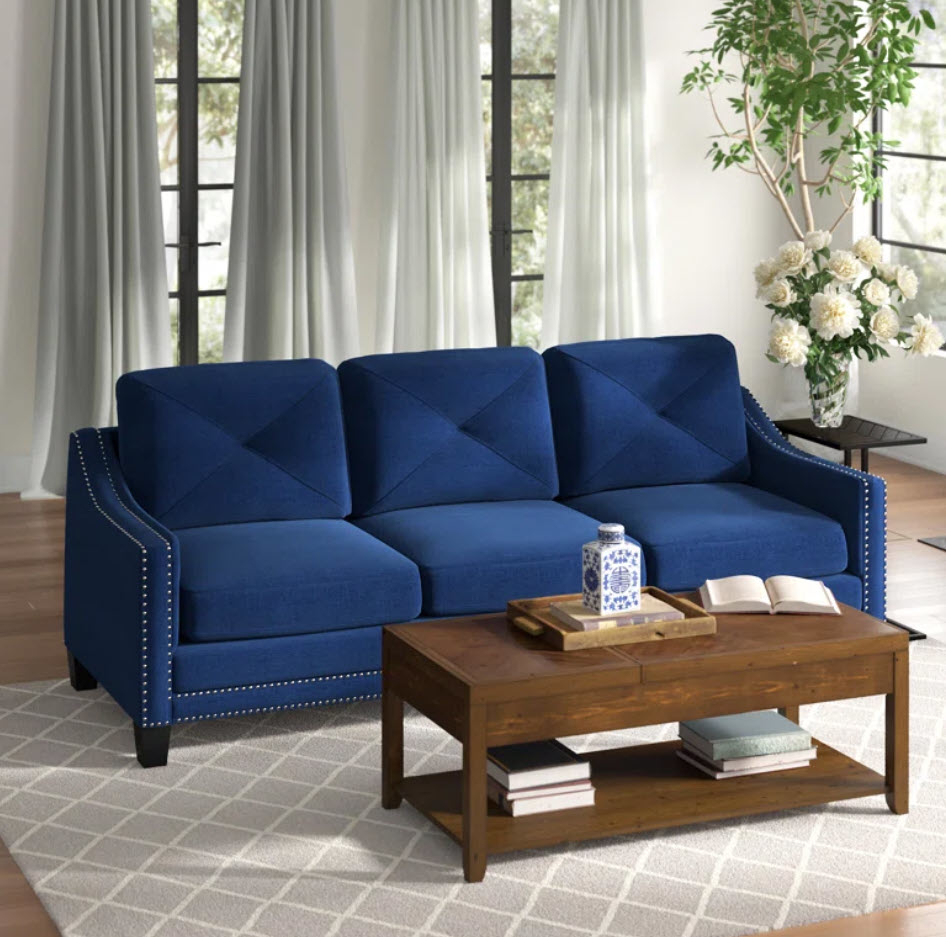 royal blue three-seater couch with nail head trim