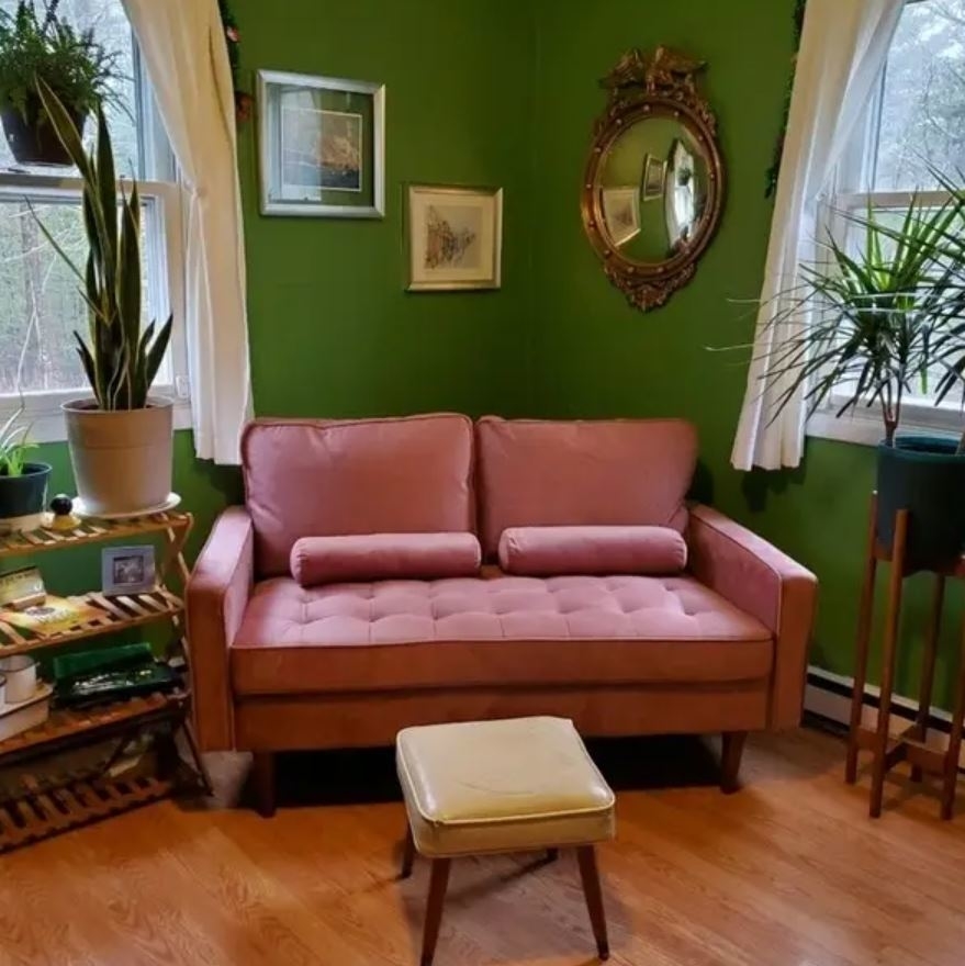 pink tufted small loveseat in living space