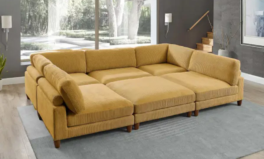 huge yellow couch that can serve as a large bed for the whole family with cushions