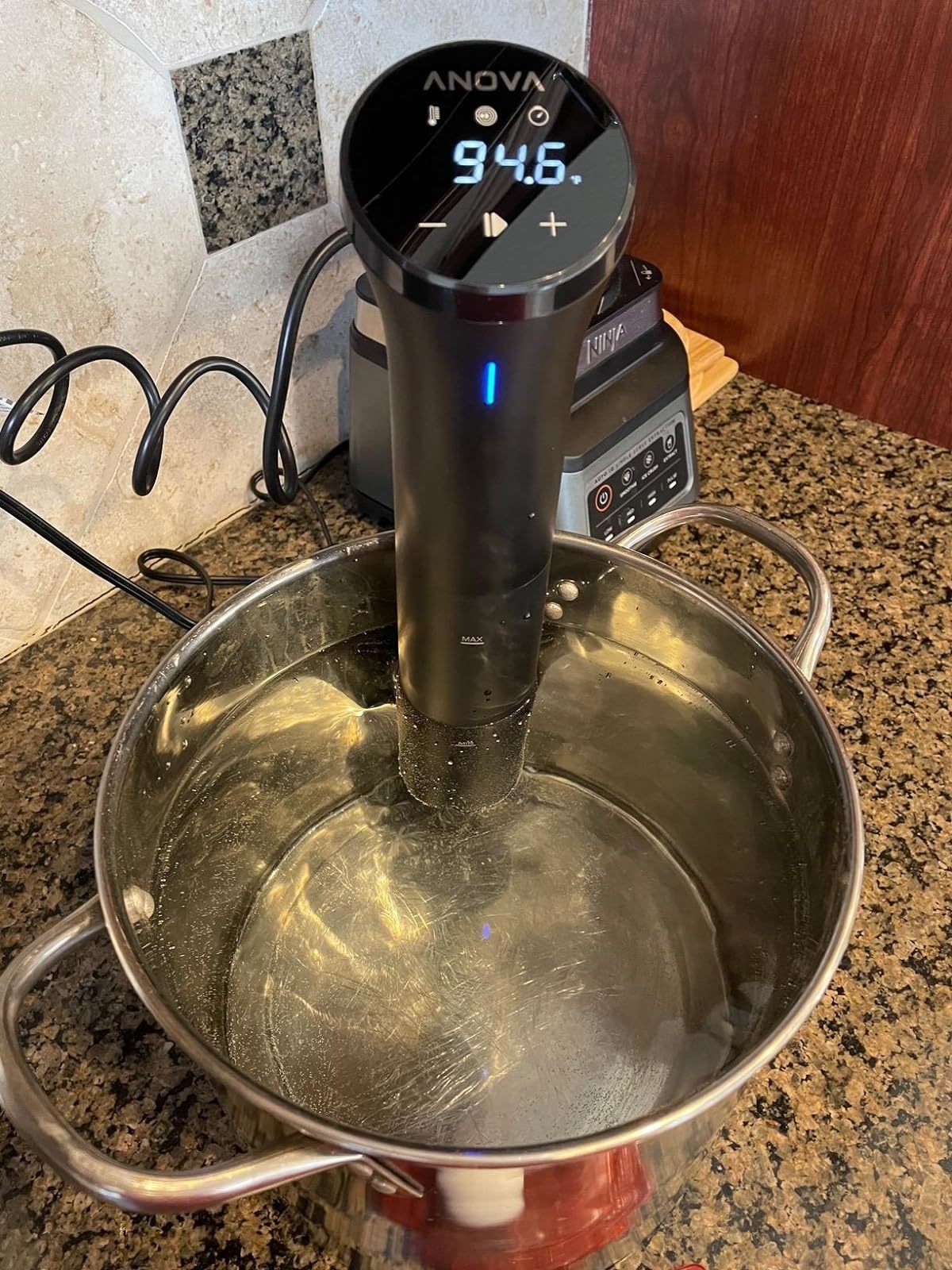 the sous vide in a pan that displays the temperature 94.6