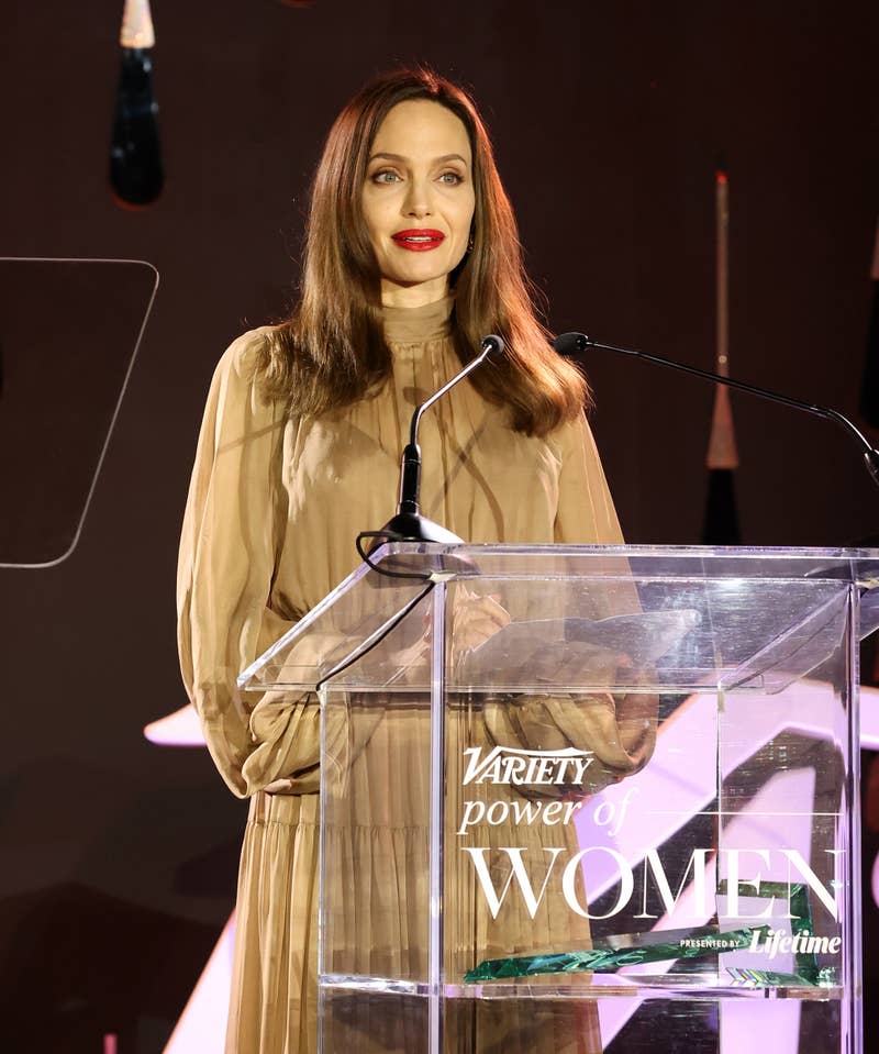 Angelina speaking behing a podium for variety power of women event