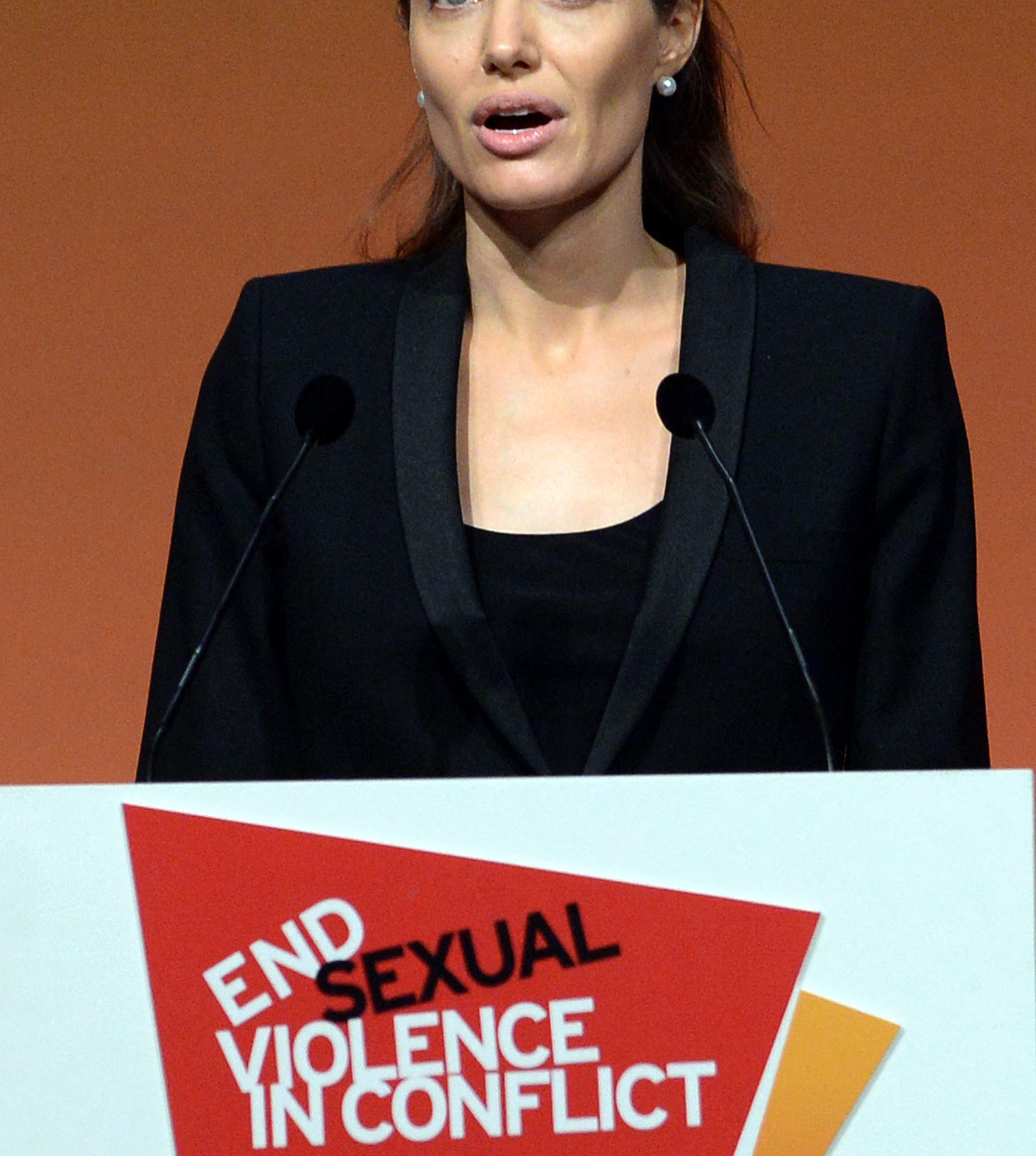 Angelina speaking behind a podium
