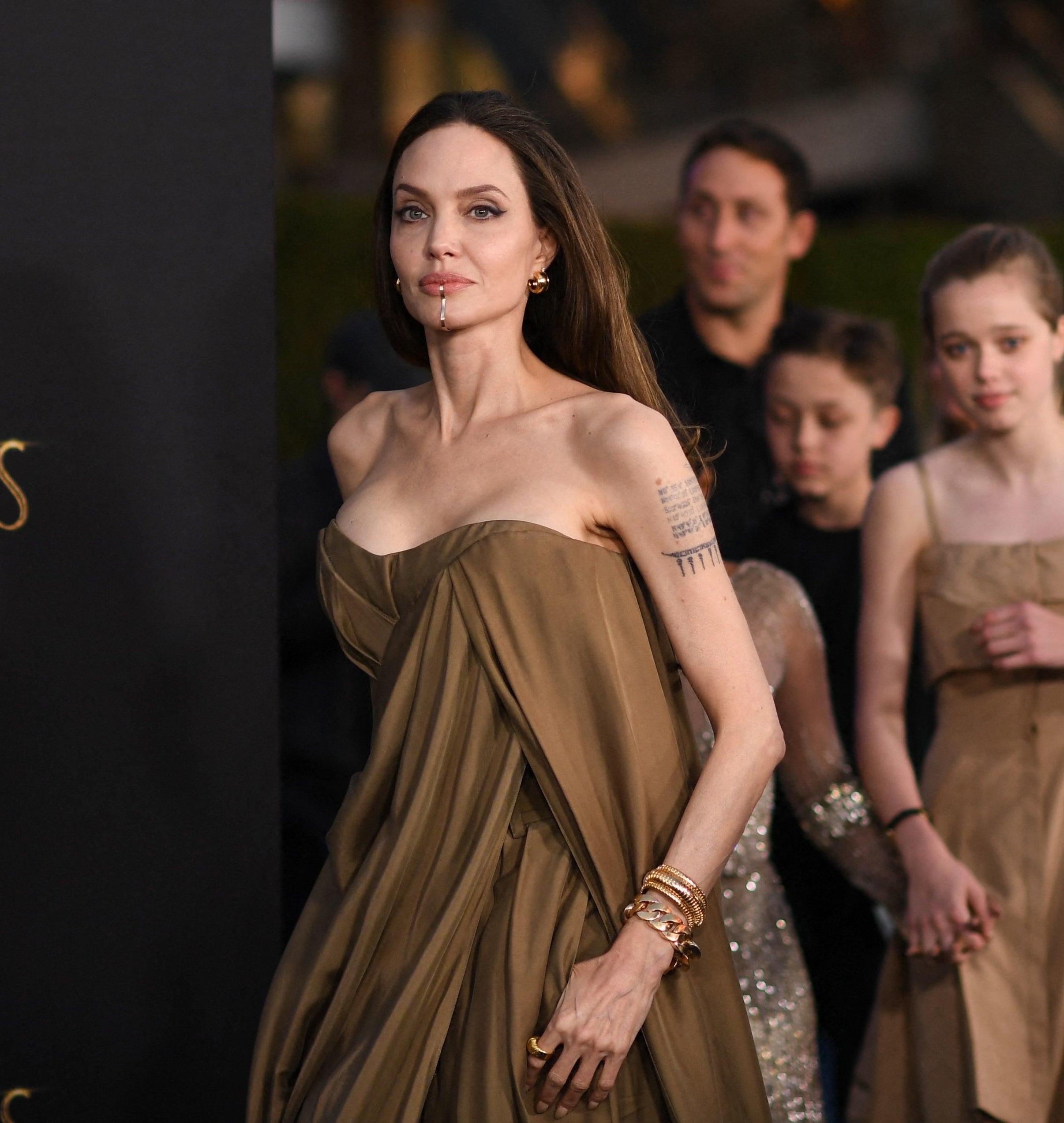 closeup of angelina with her kids following close behind
