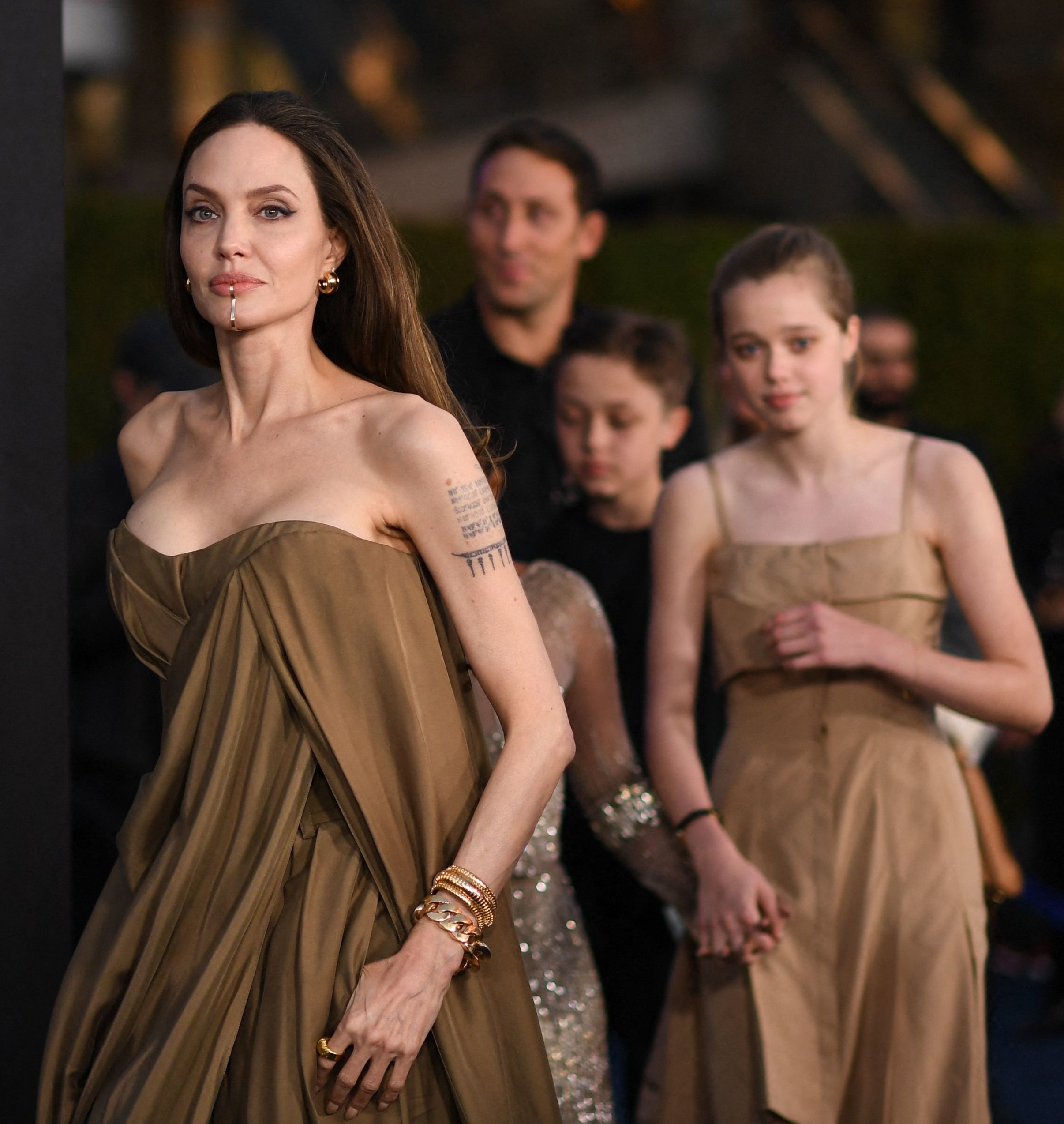 closeup of angelina with her kids following close behind