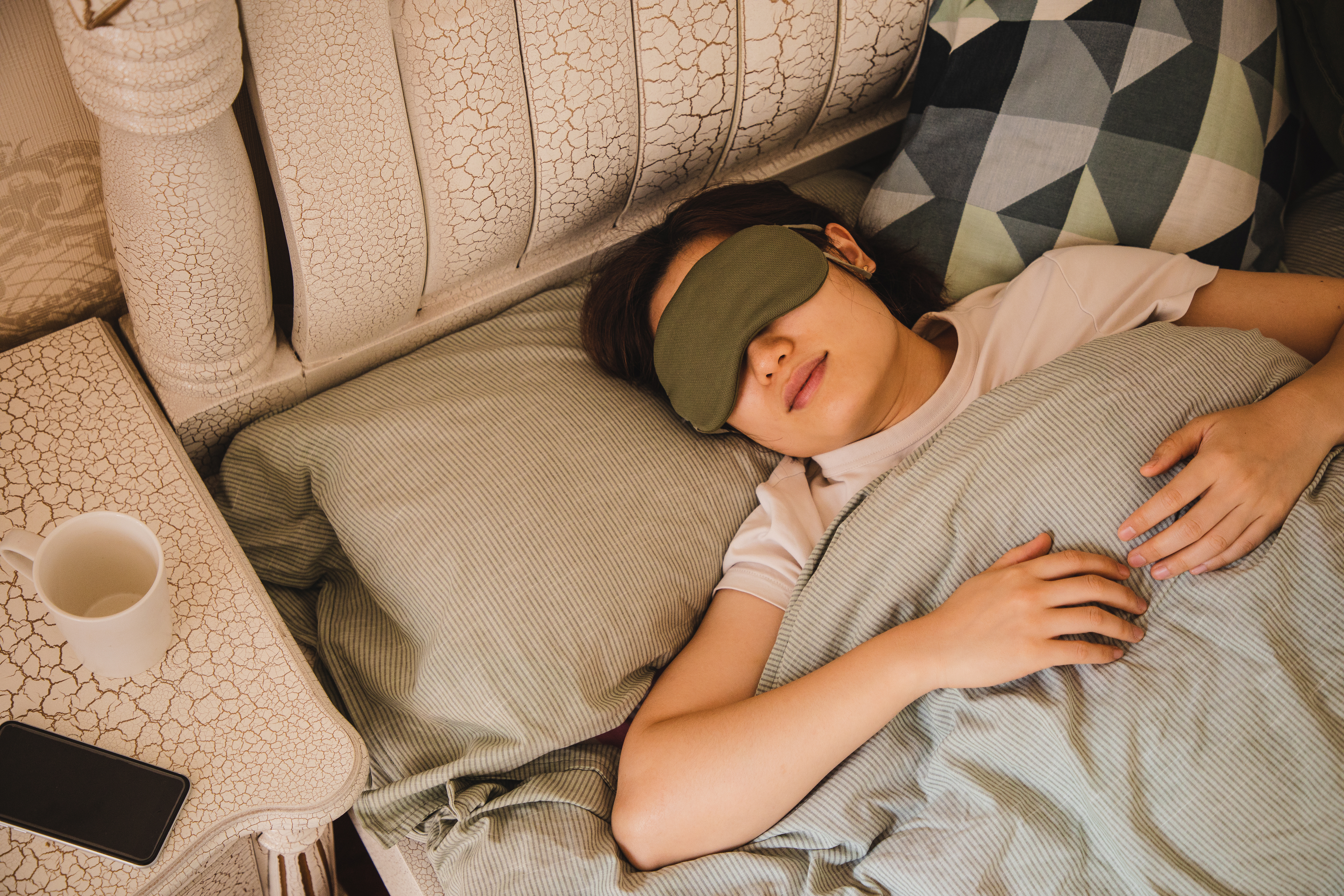 a person sleeping with a sleep mask