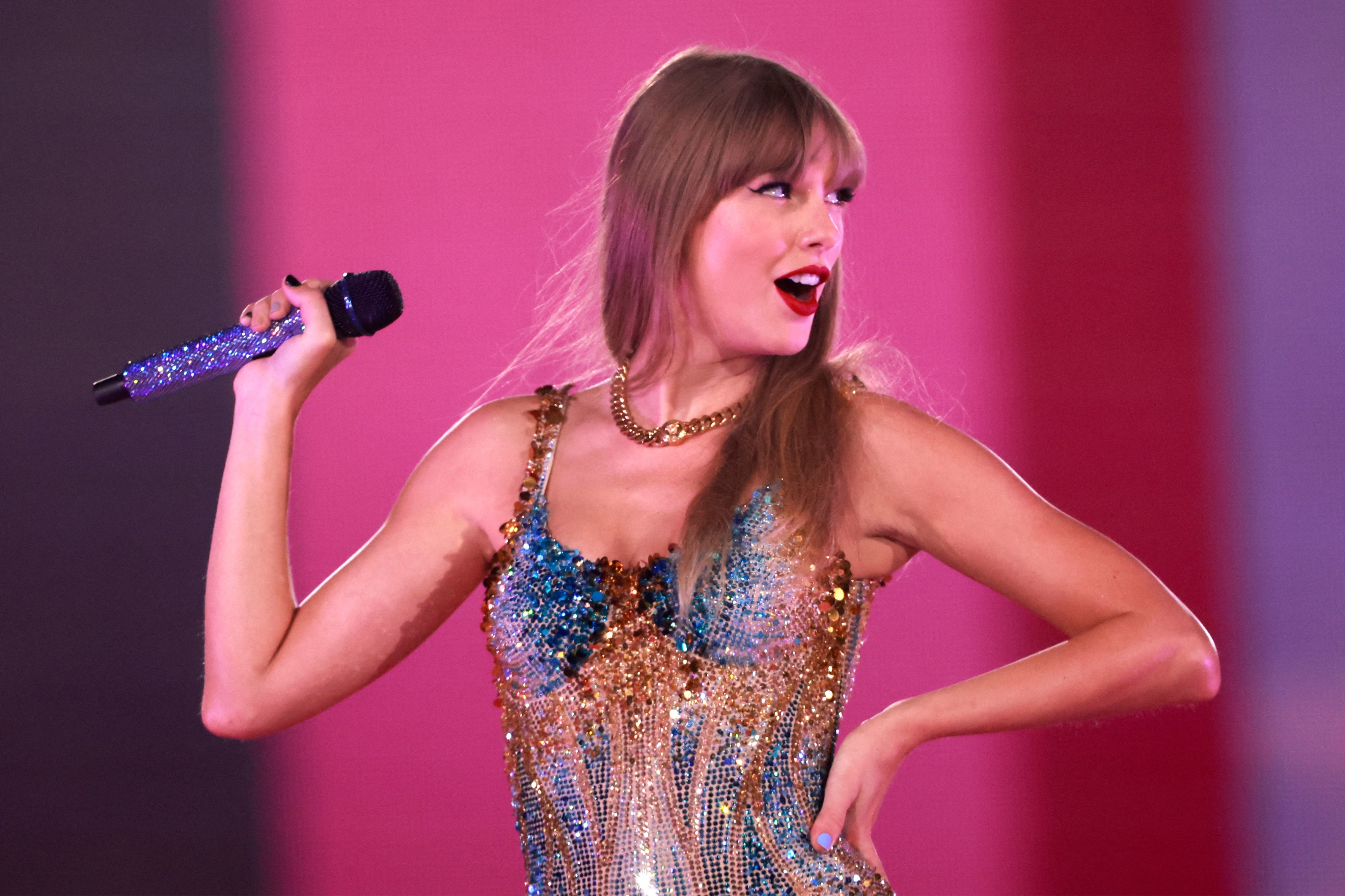taylor on stage with a mic