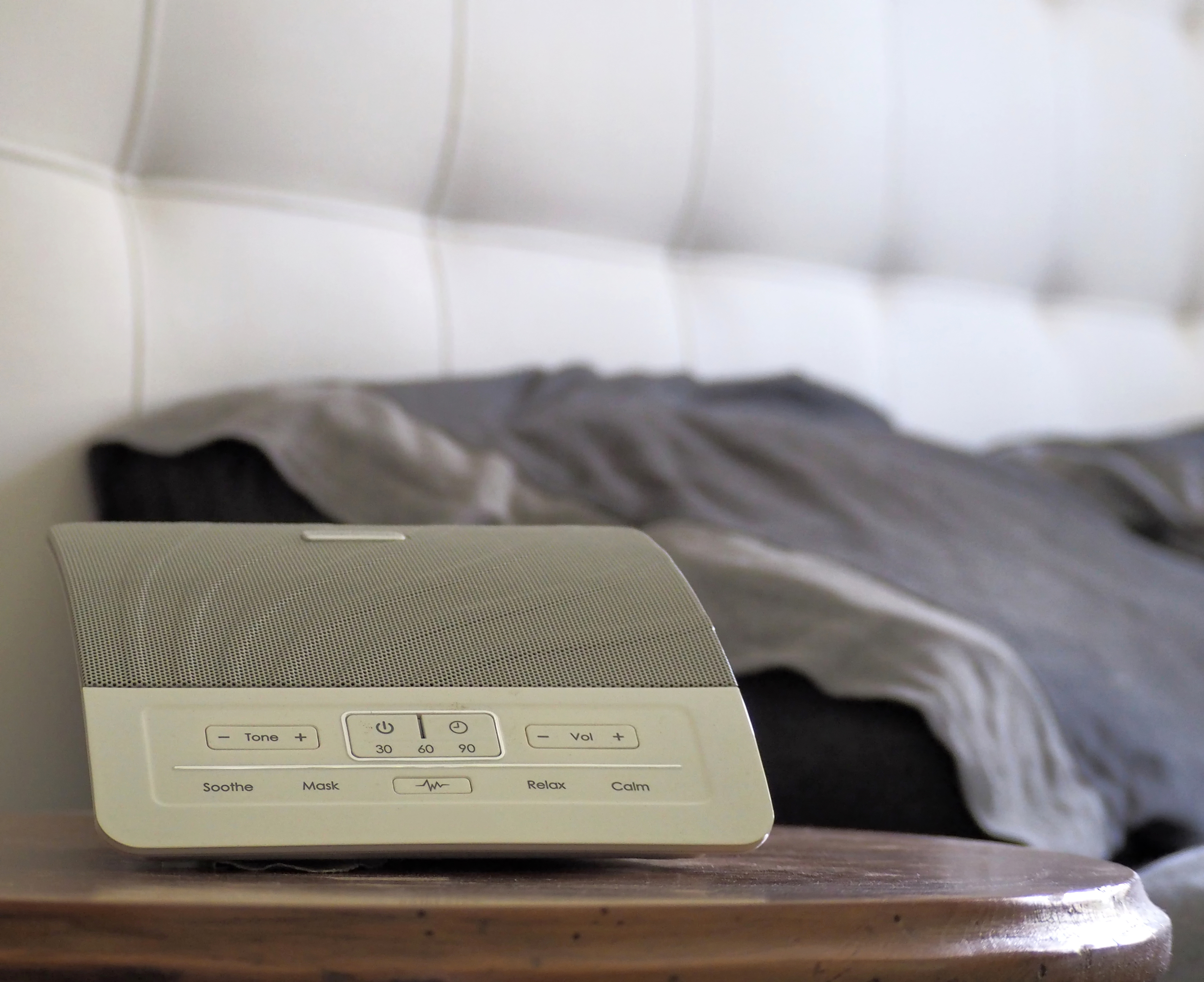 a white noise machine next to bed