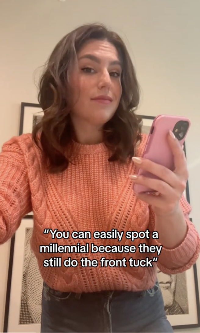 person on camera saying you can easily spot a millennial because they still do the front tuck