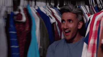 Tan France crawling away in a closet