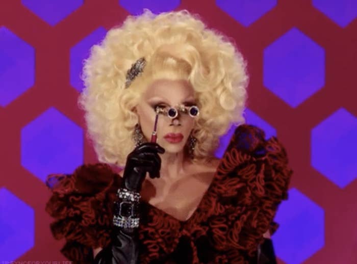 RuPaul holding up binoculars