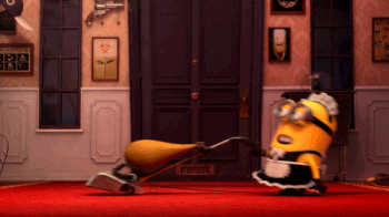 a gif of a minion dressed like  a maid from &quot;Despicable Me 2&quot; running the vacuum and doing a dance