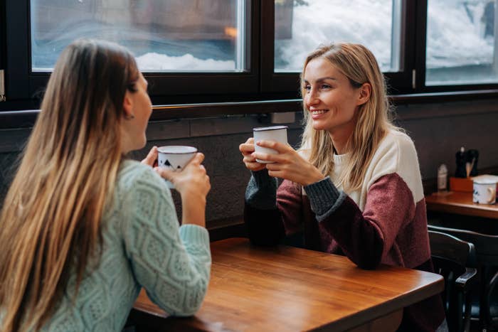 two women talking at a bar