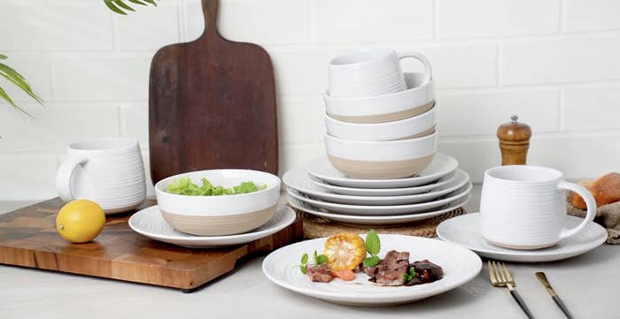 The dish set on a counter with cutting boards and food