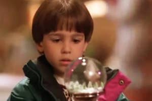 Kid from "The Santa Clause" looking at a snow globe. 