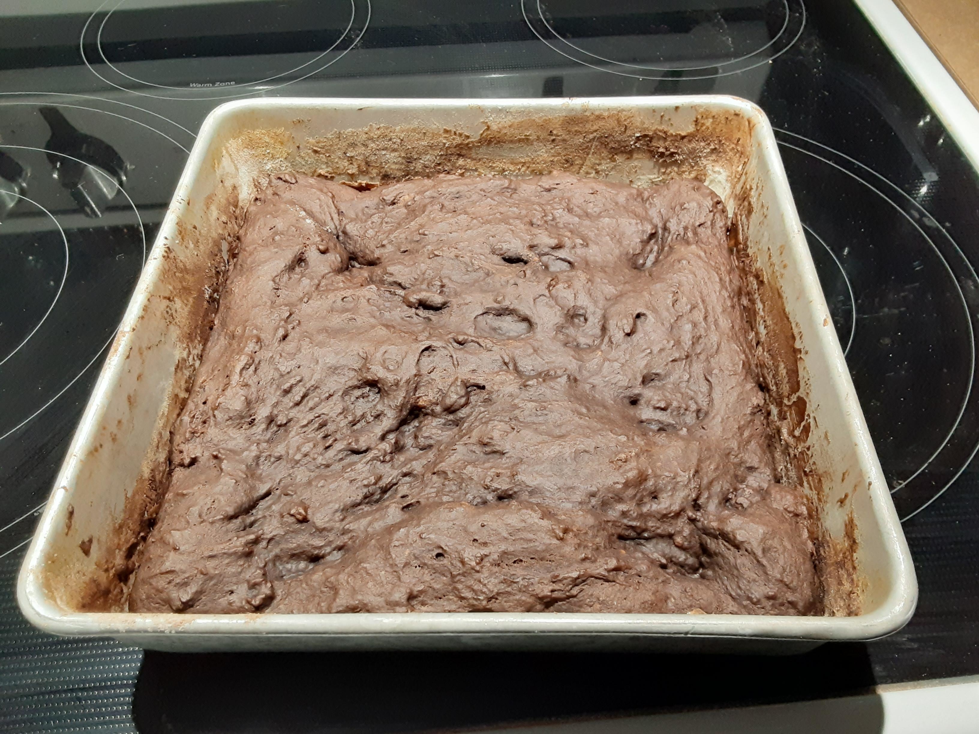 a lumpy, sugarless chocolate cake in a square pan
