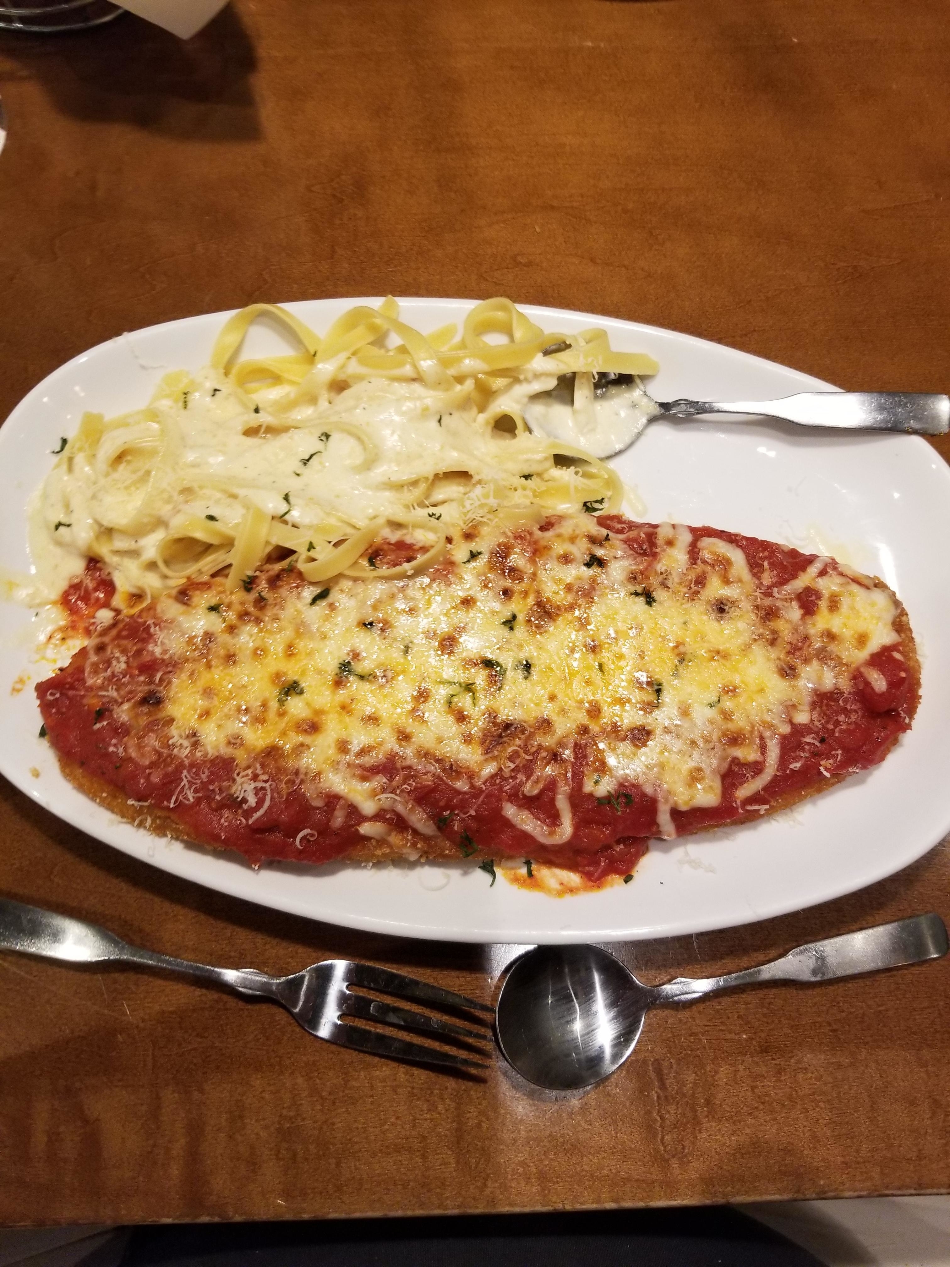 a plate of olive garden chicken parm and spaghetti