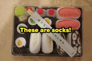 reviewer image of the box of sushi-shaped socks and text that reads these are socks