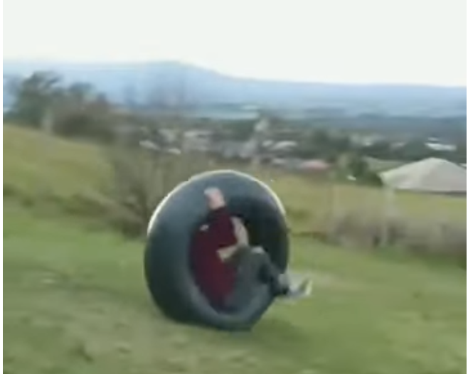 a person rolling in a tire