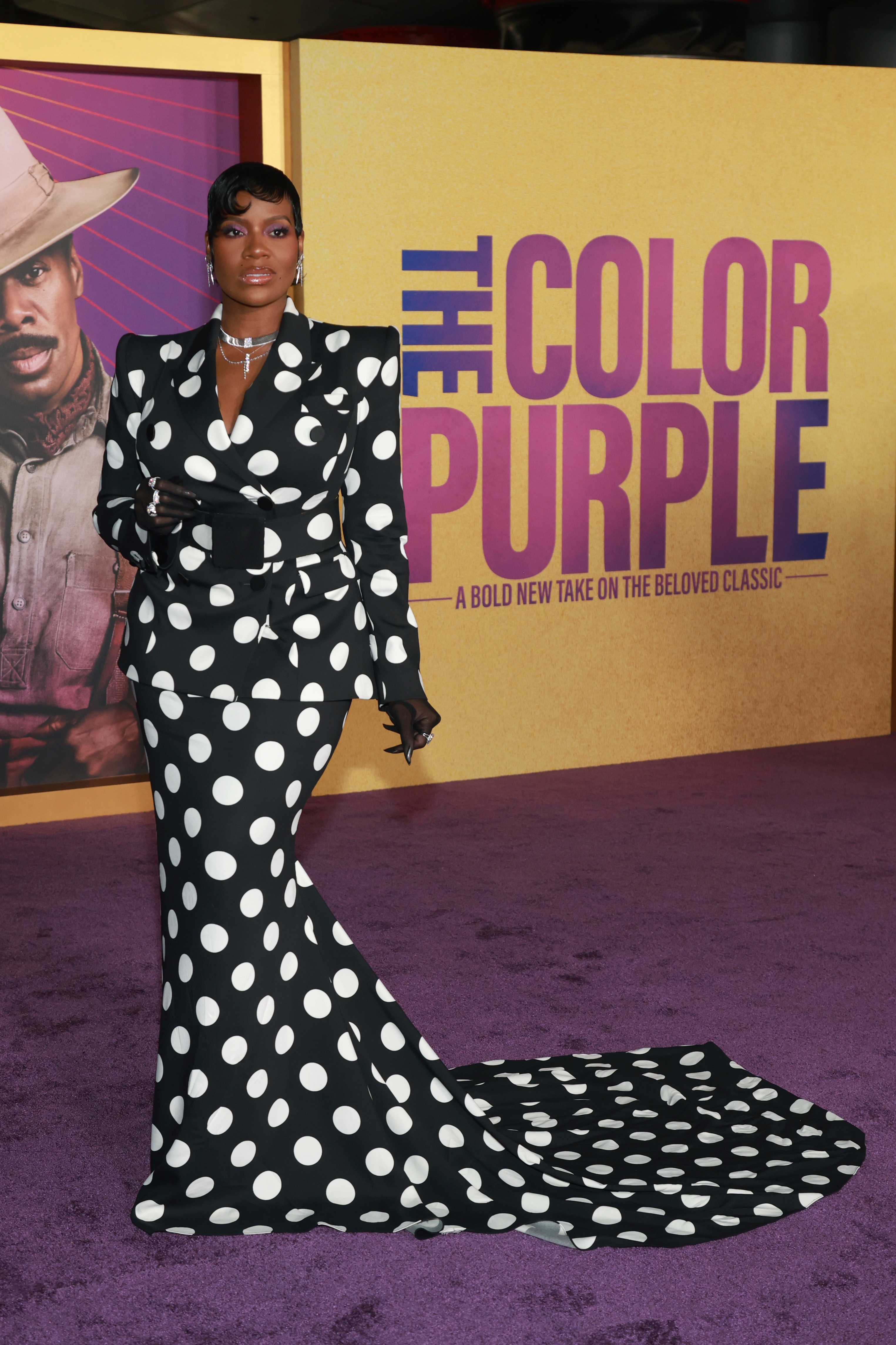Fantasia in a long-sleeved two-piece black gown with a train and large white polka dots