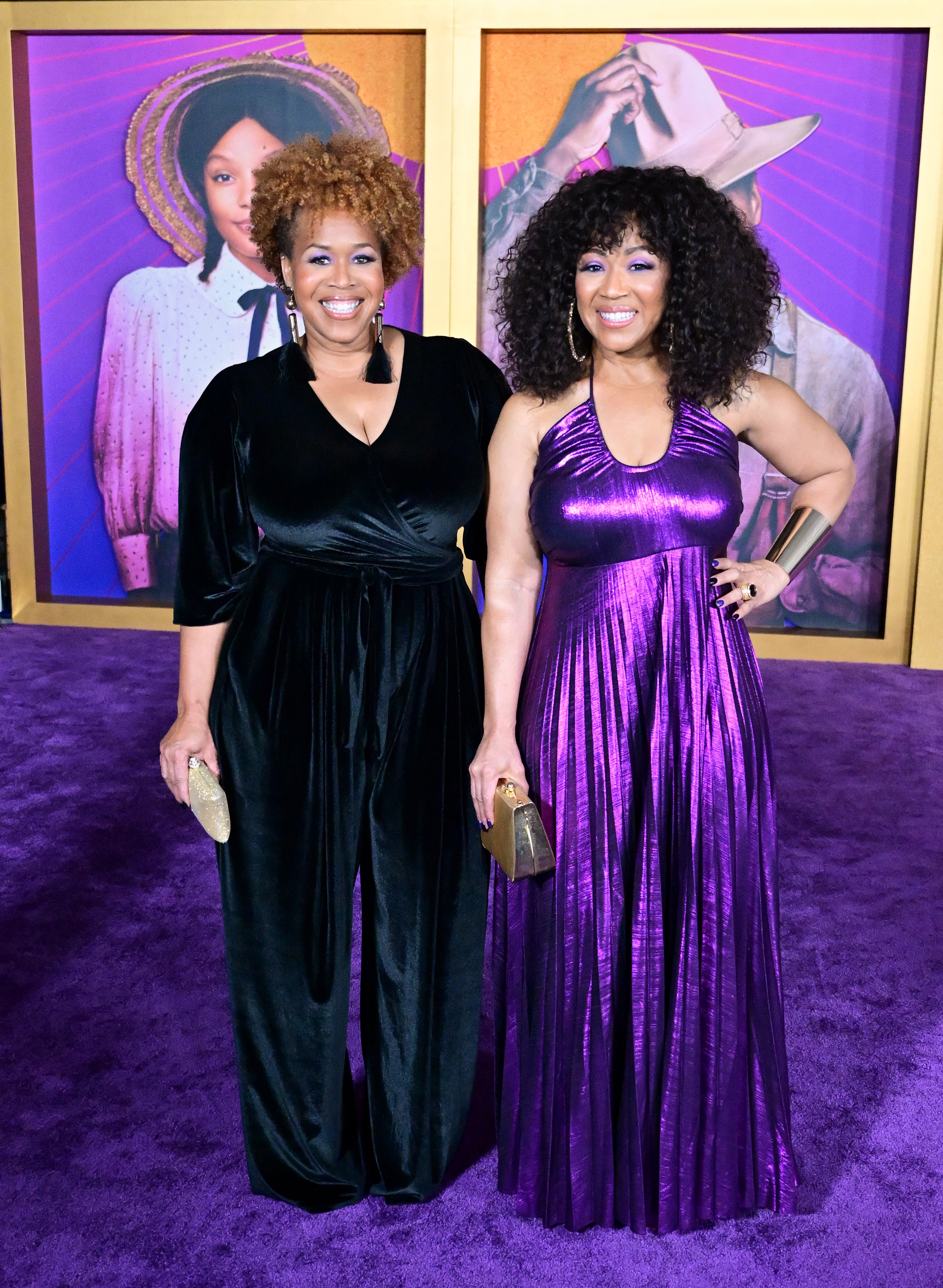 Erica Atkins-Campbell in a bluish short-sleeved pantsuit and Trecina Atkins-Campbell in a purple sleeveless gown