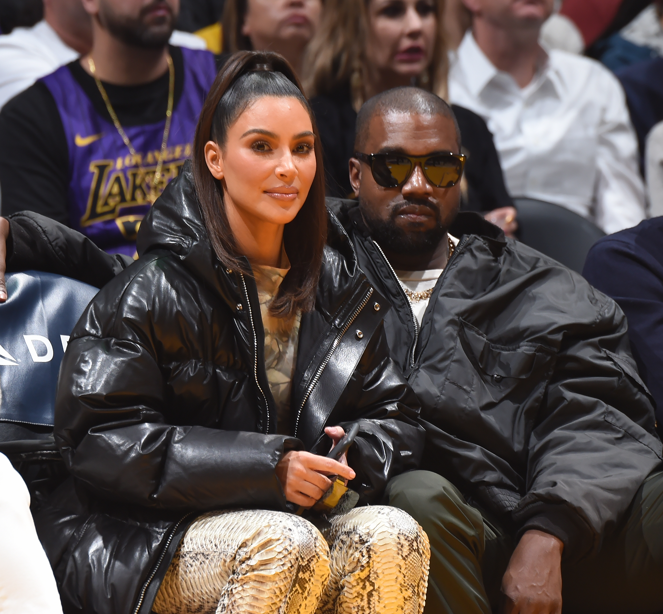 Close-up of Kim and Ye sitting together in an audience