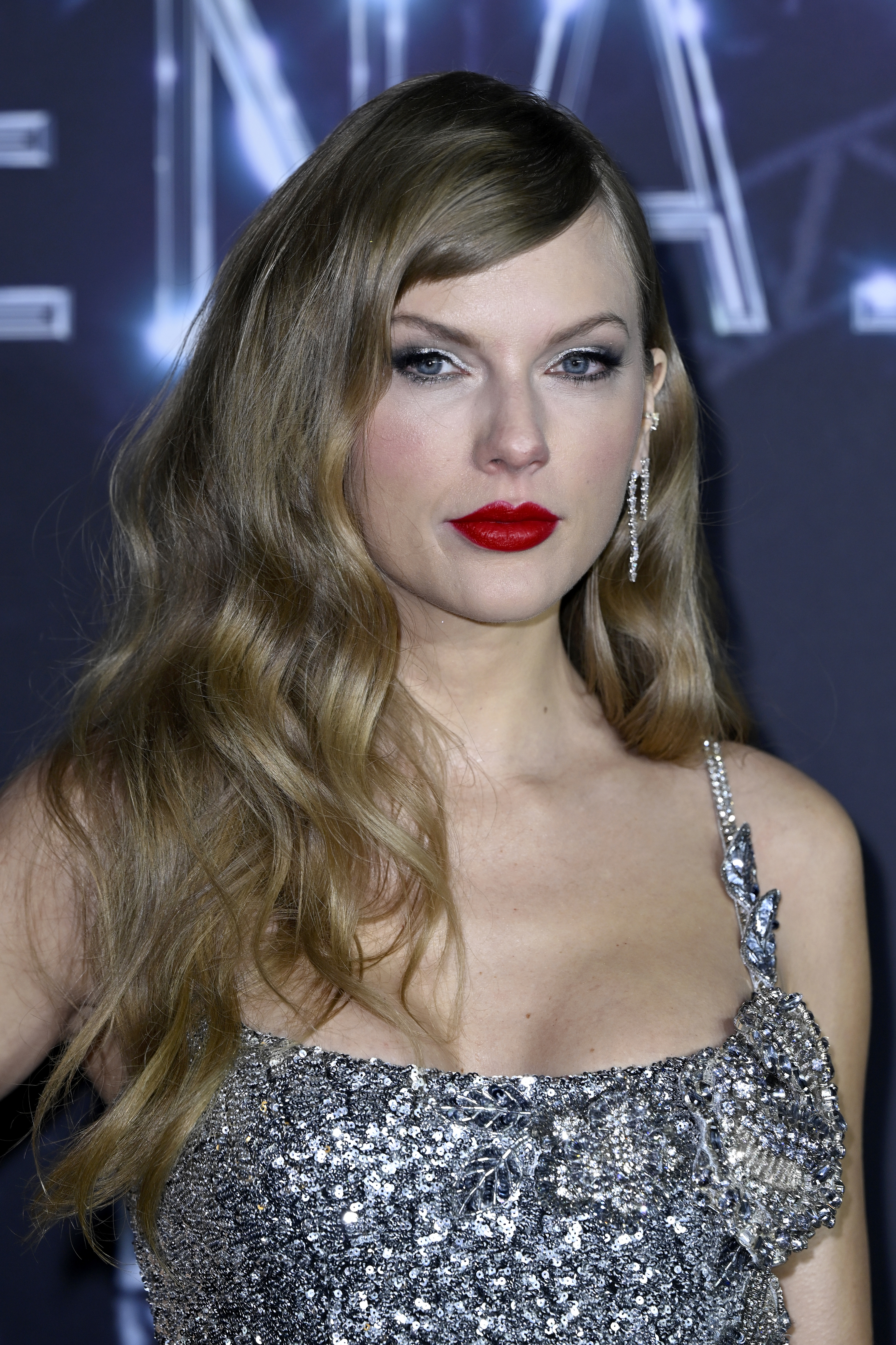 Close-up of Taylor in a bejeweled outfit at a media event