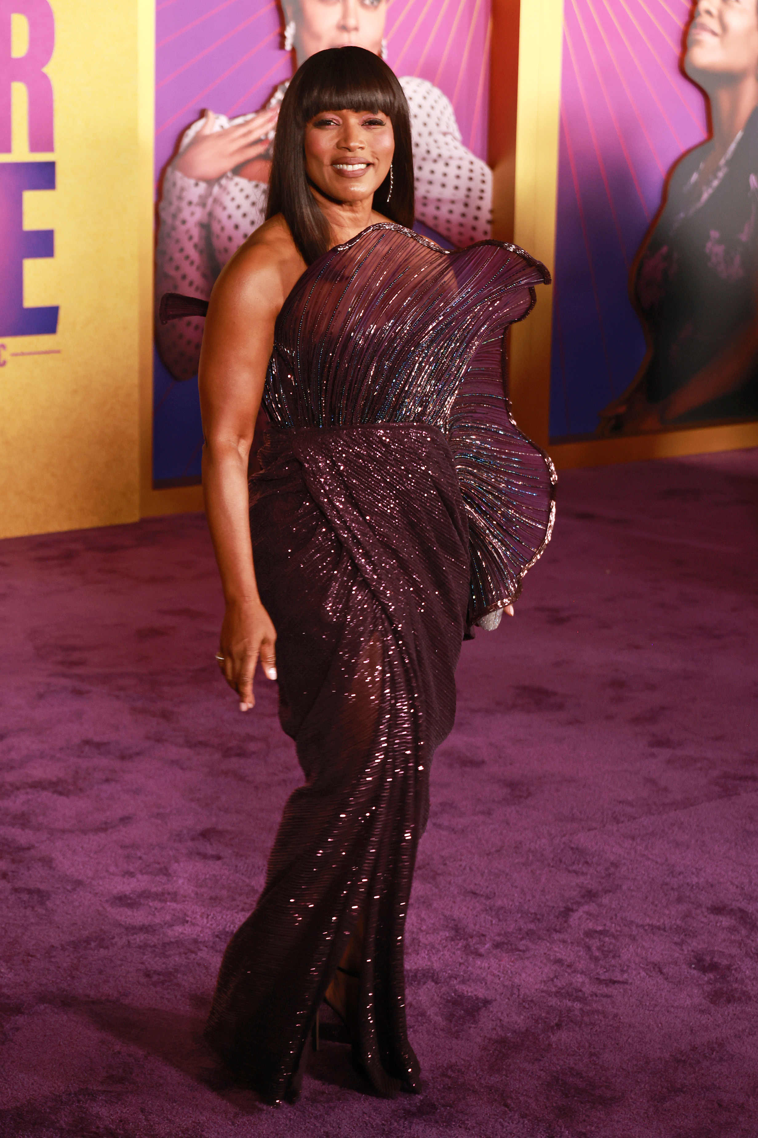 Angela in a sparkly sleeveless, one-shoulder purplish gown