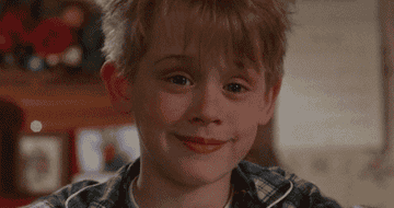 Kevin McAllister from Home Alone smirks and raises his eyebrows.