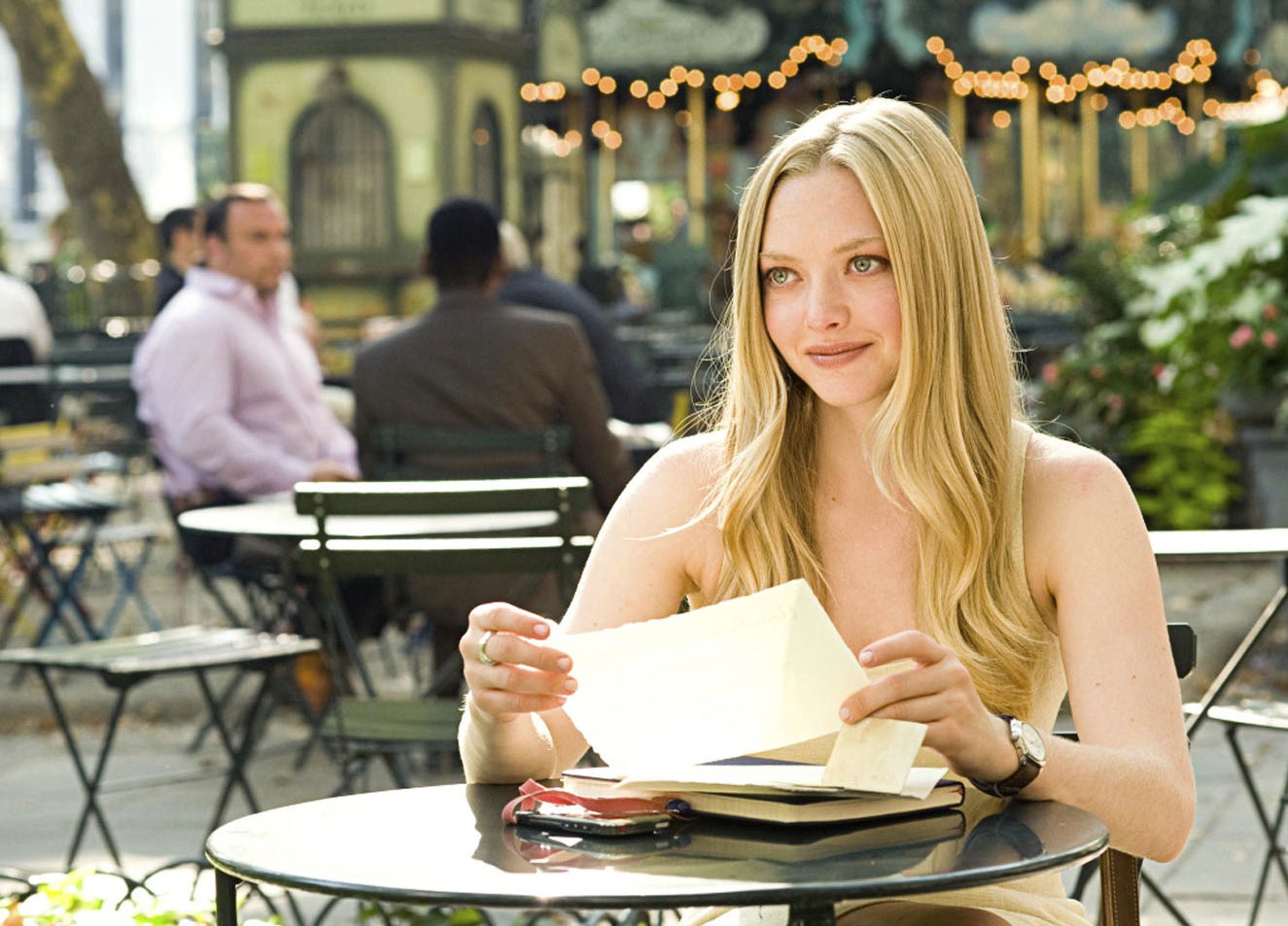 her character sitting at a cafe table with a letter