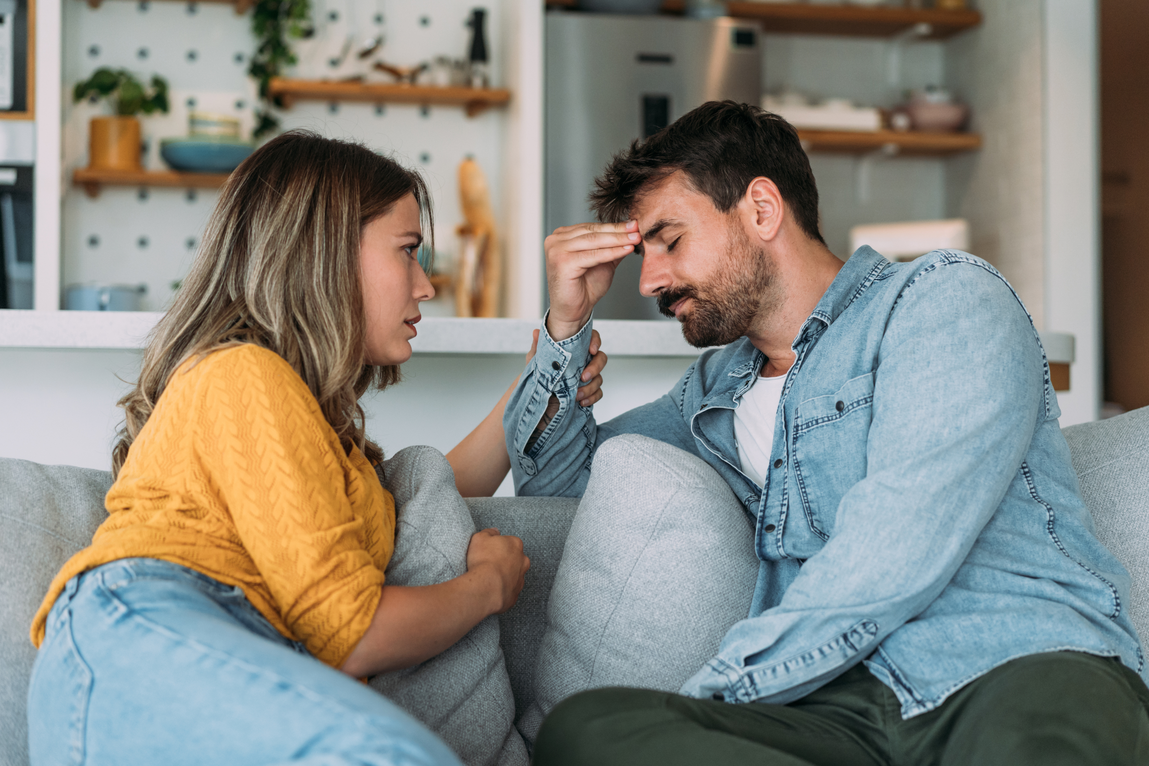 a man upset with a woman on the couch