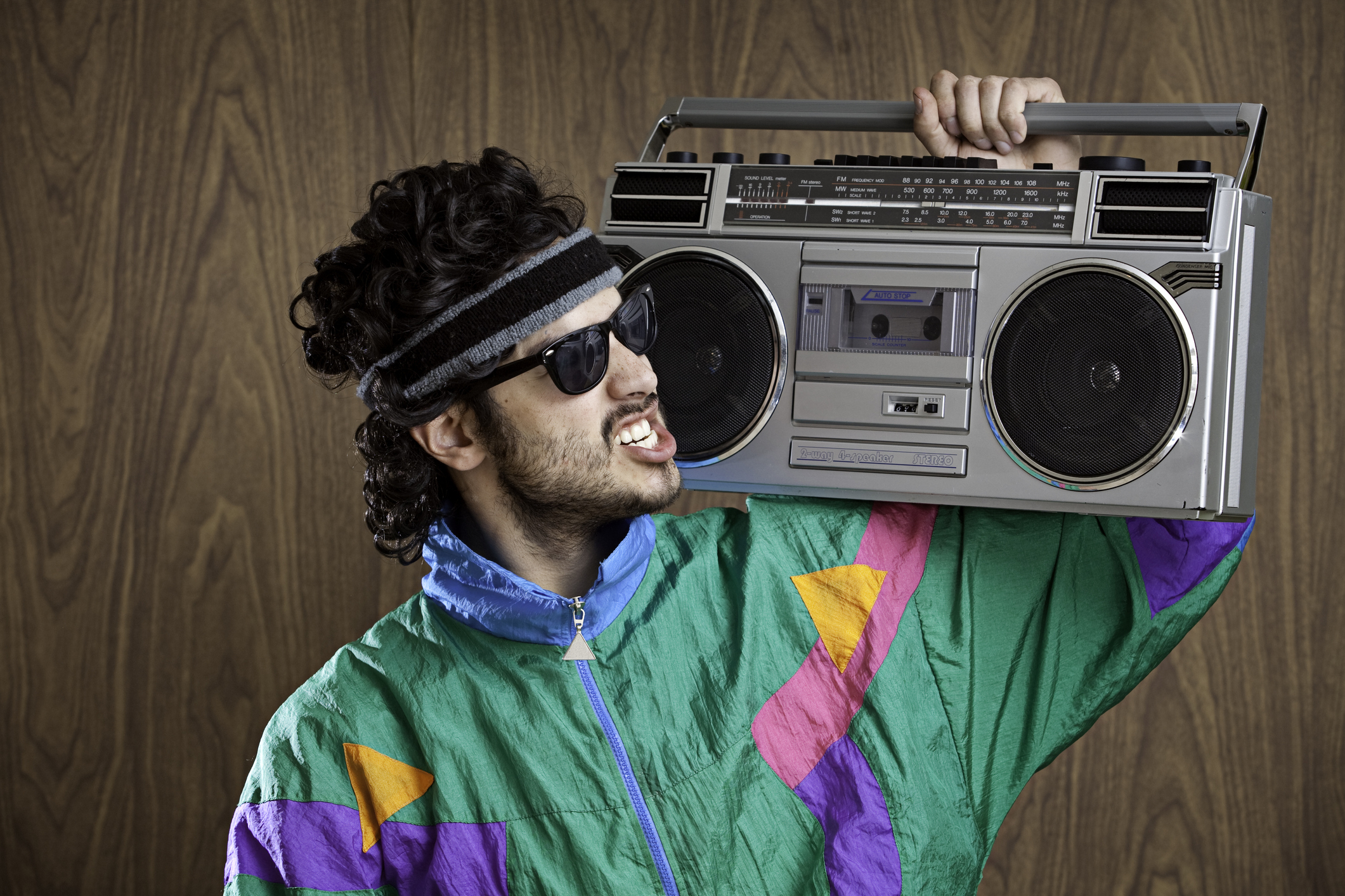 A man with a boombox on his shoulder