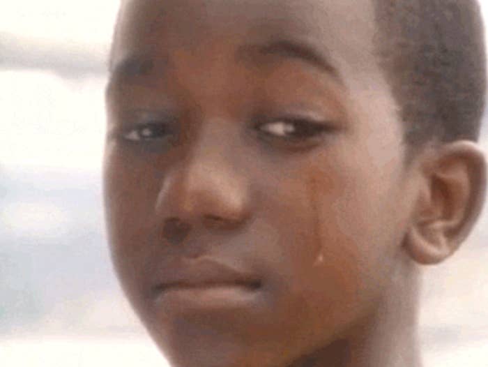 Close-up of meme showing a young boy with a tear rolling down his eye