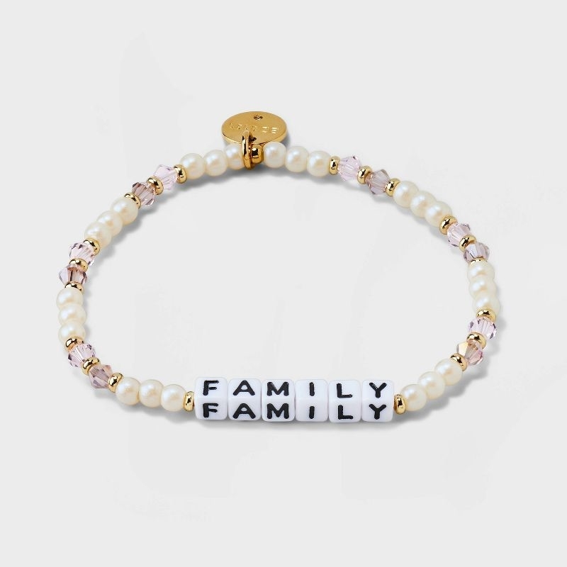 the bracelet in pearl and crystal with brass hardware and beads that read &quot;family&quot;
