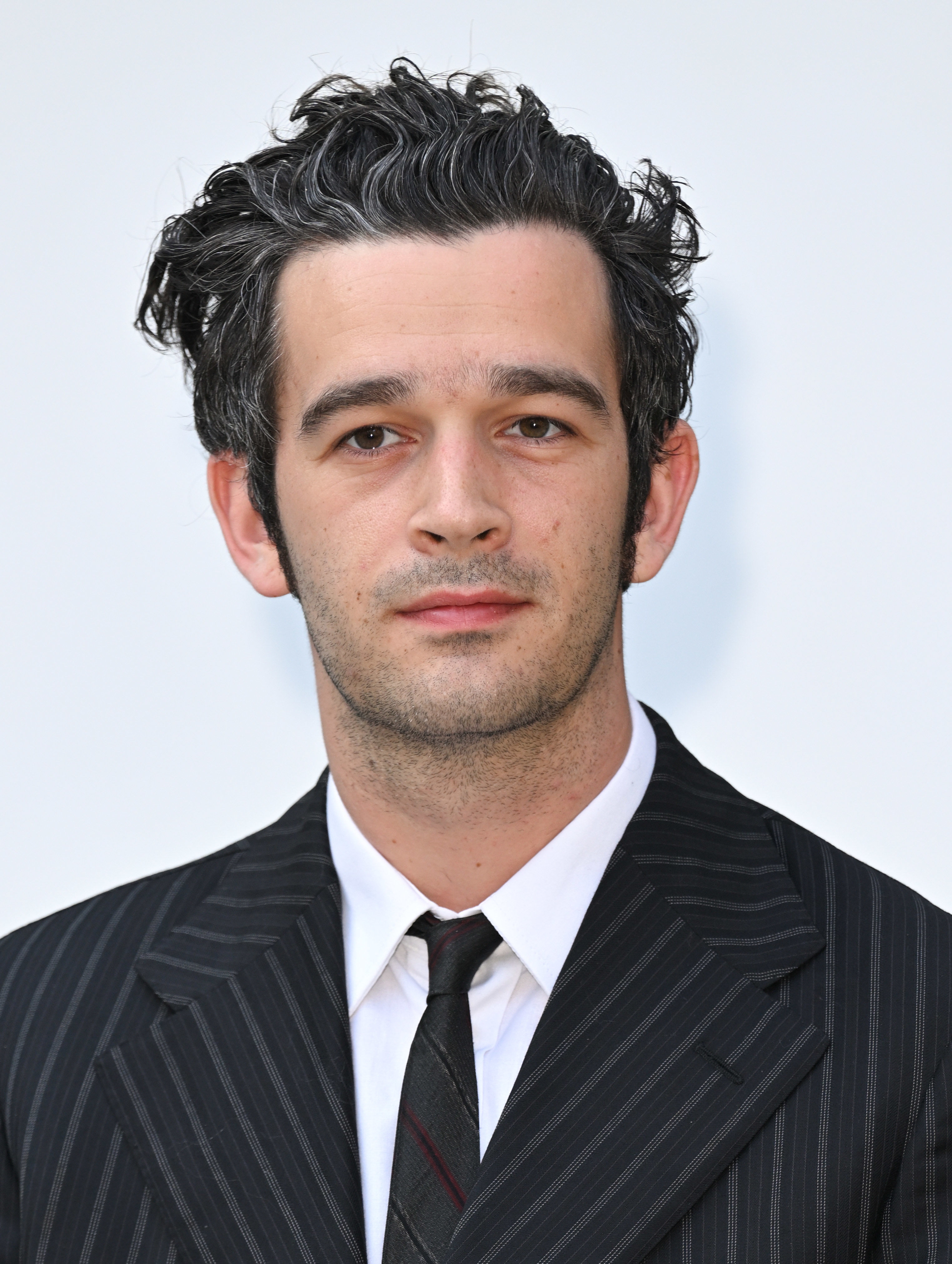 Close-up of Matty in a suit and tie