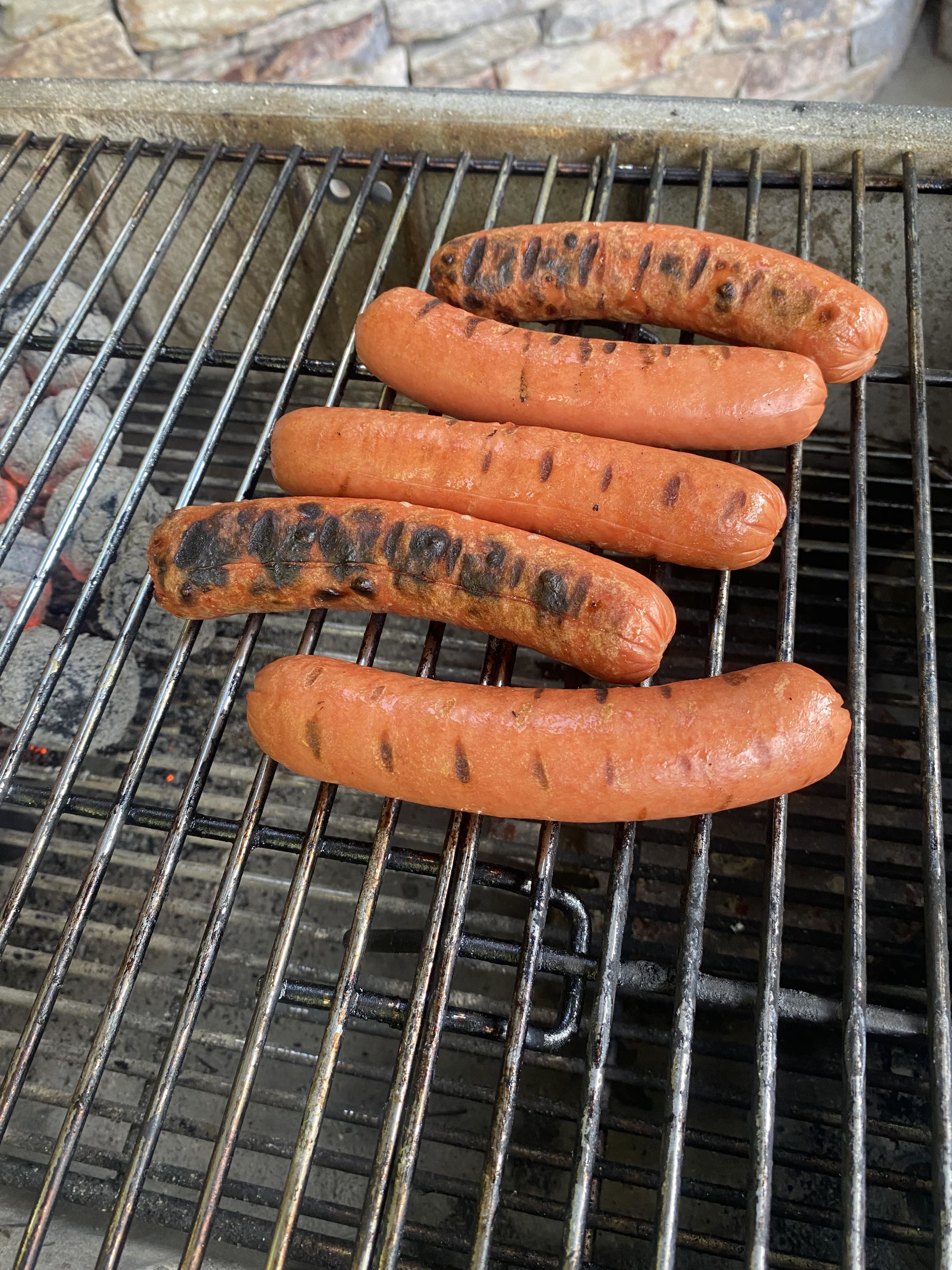 burnt hot dogs on a grill