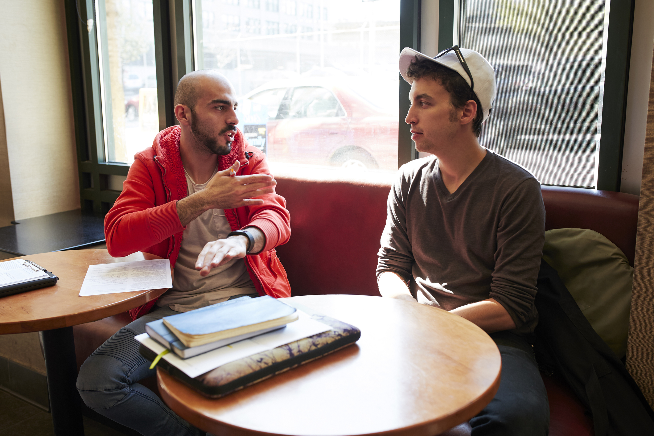 Two men sitting in a cafe and talking
