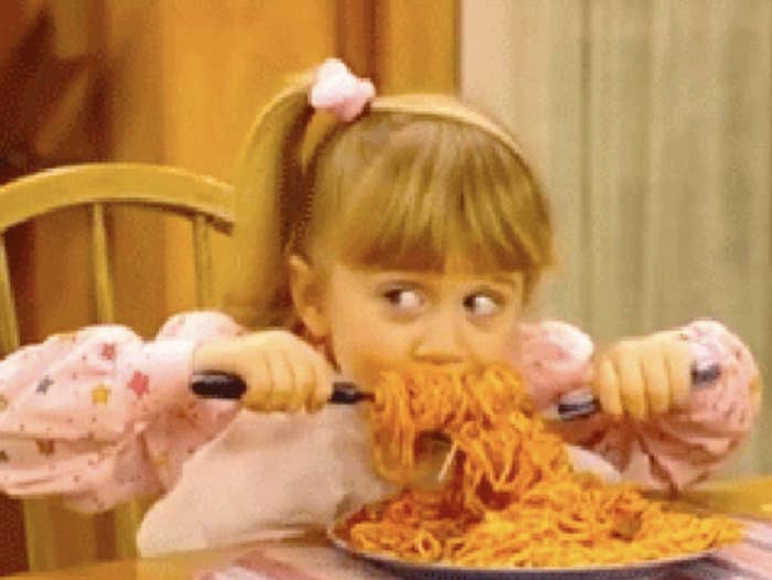 kids eating large spoonfuls of spaghetti
