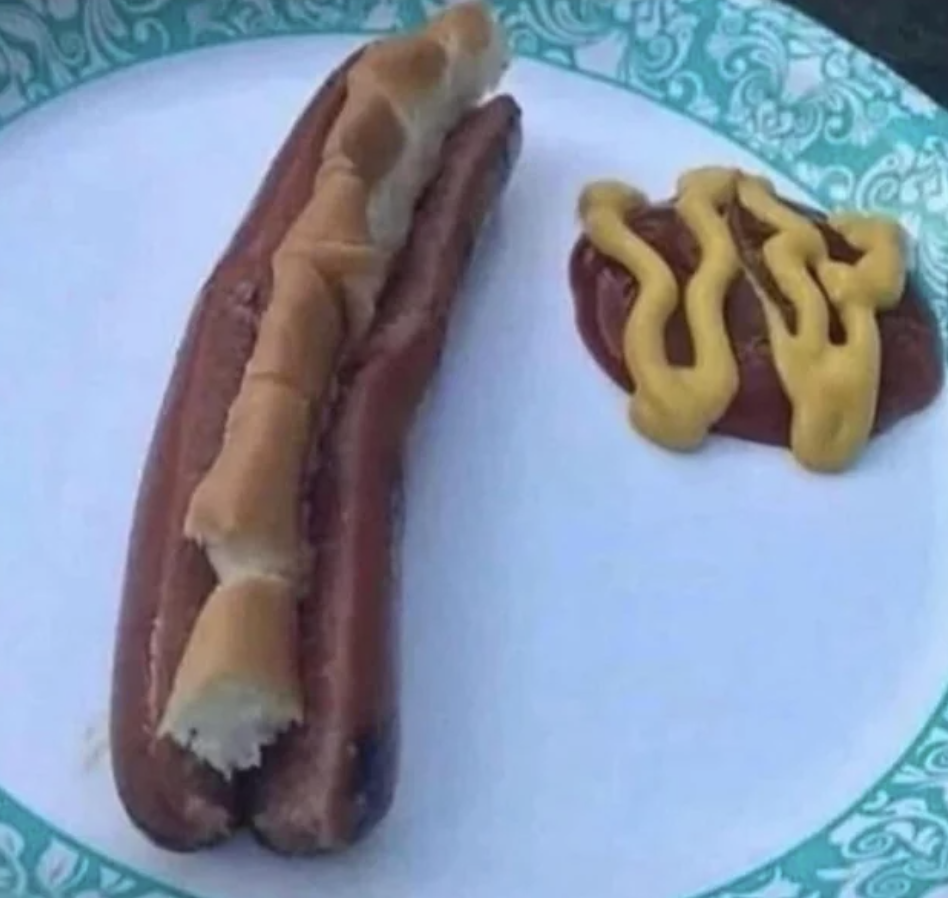 a split hot dog with pieces of bread in it