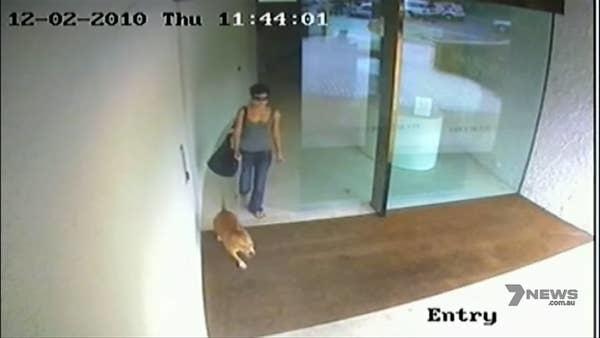 ctv footage of her walking out of a building with a dog