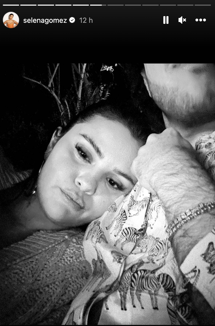 Selena snuggling apparently with Benny, whose arm is visible but not his entire face