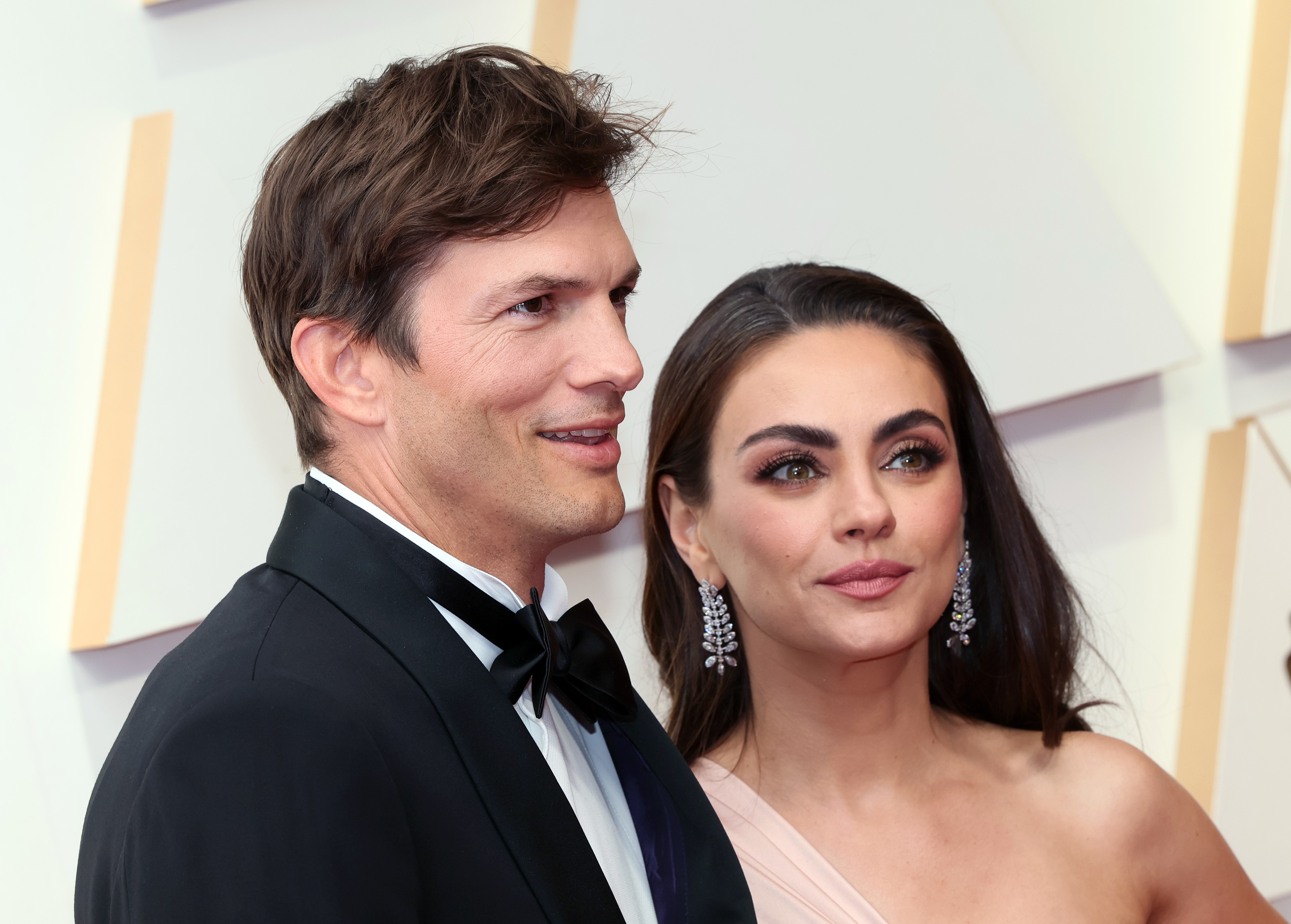 Close-up of Ashton and Mila at a media event