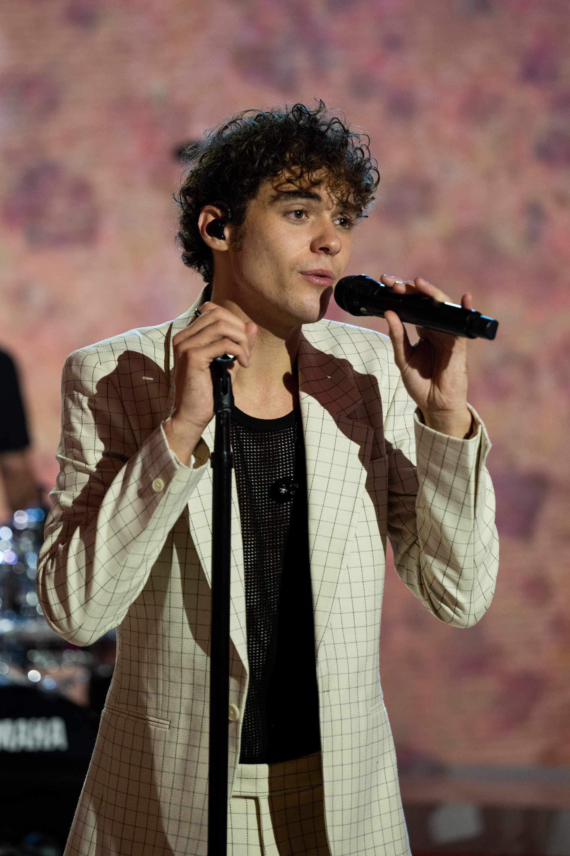 closeup of Joshua singing into a mic