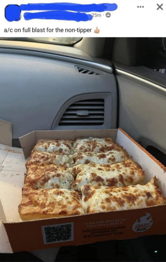 An opened pizza in front of the air conditioning vents