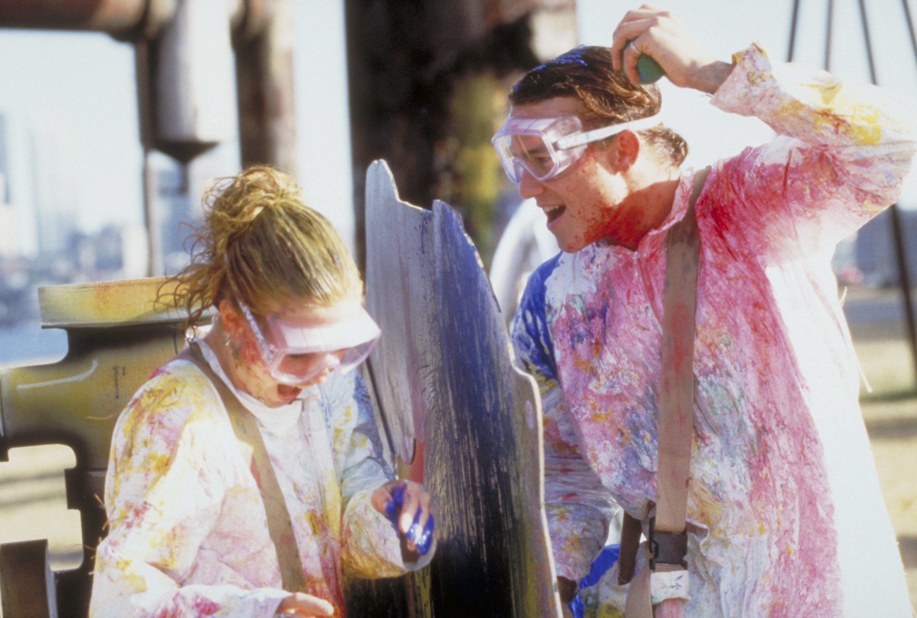 Julia and Heath in the movie painting and wearing goggles