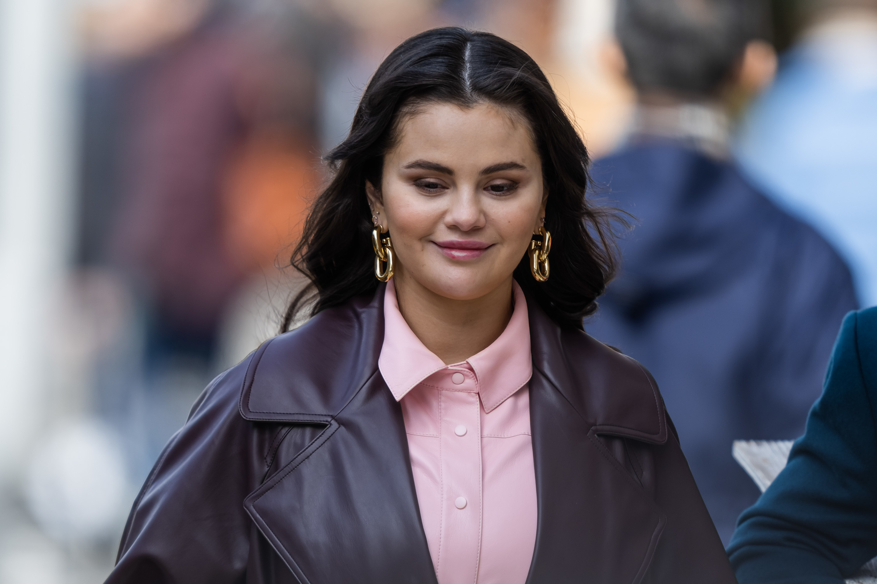 Close-up of Selena smiling and wearing a blouse and jacket