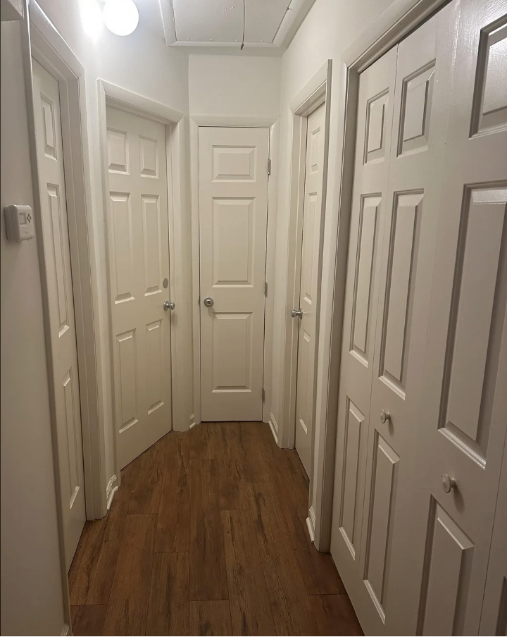 A hallway with a bunch of doors